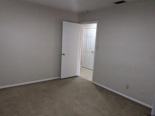 a view of an empty room and closet area