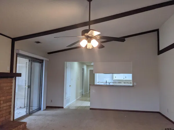 a view of a room with a large mirror and fan