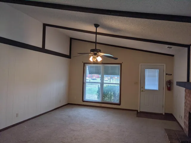 a view of an empty room with windows