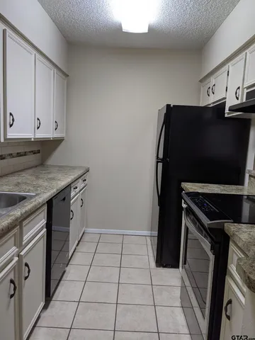 a kitchen with a refrigerator and a stove