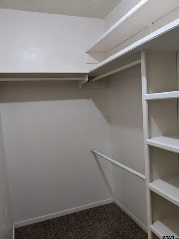 a view of storage and utility room with racks on the wall