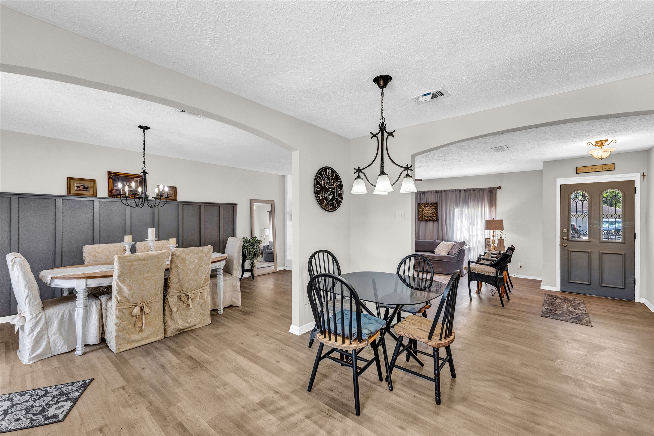2705 Parrott Avenue Rosenberg, TX 77471 - Photo 15 of 27 a view of a dining room and livingroom with furniture wooden floor a chandelier