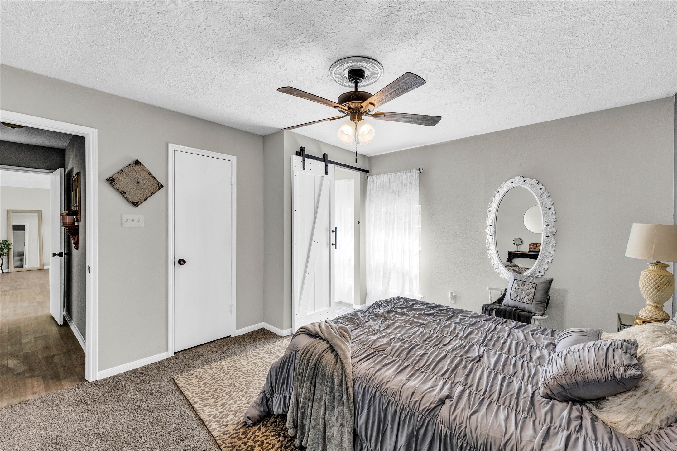 2705 Parrott Avenue Rosenberg, TX 77471 - Photo 17 of 27 a bedroom with a bed and a chandelier