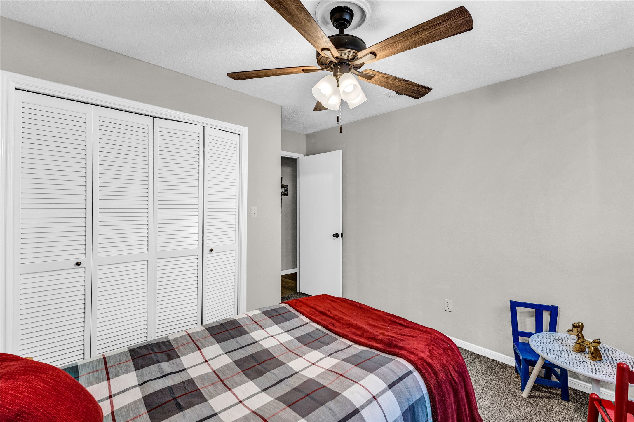 2705 Parrott Avenue Rosenberg, TX 77471 - Photo 21 of 27 a bedroom with a bed and a chandelier