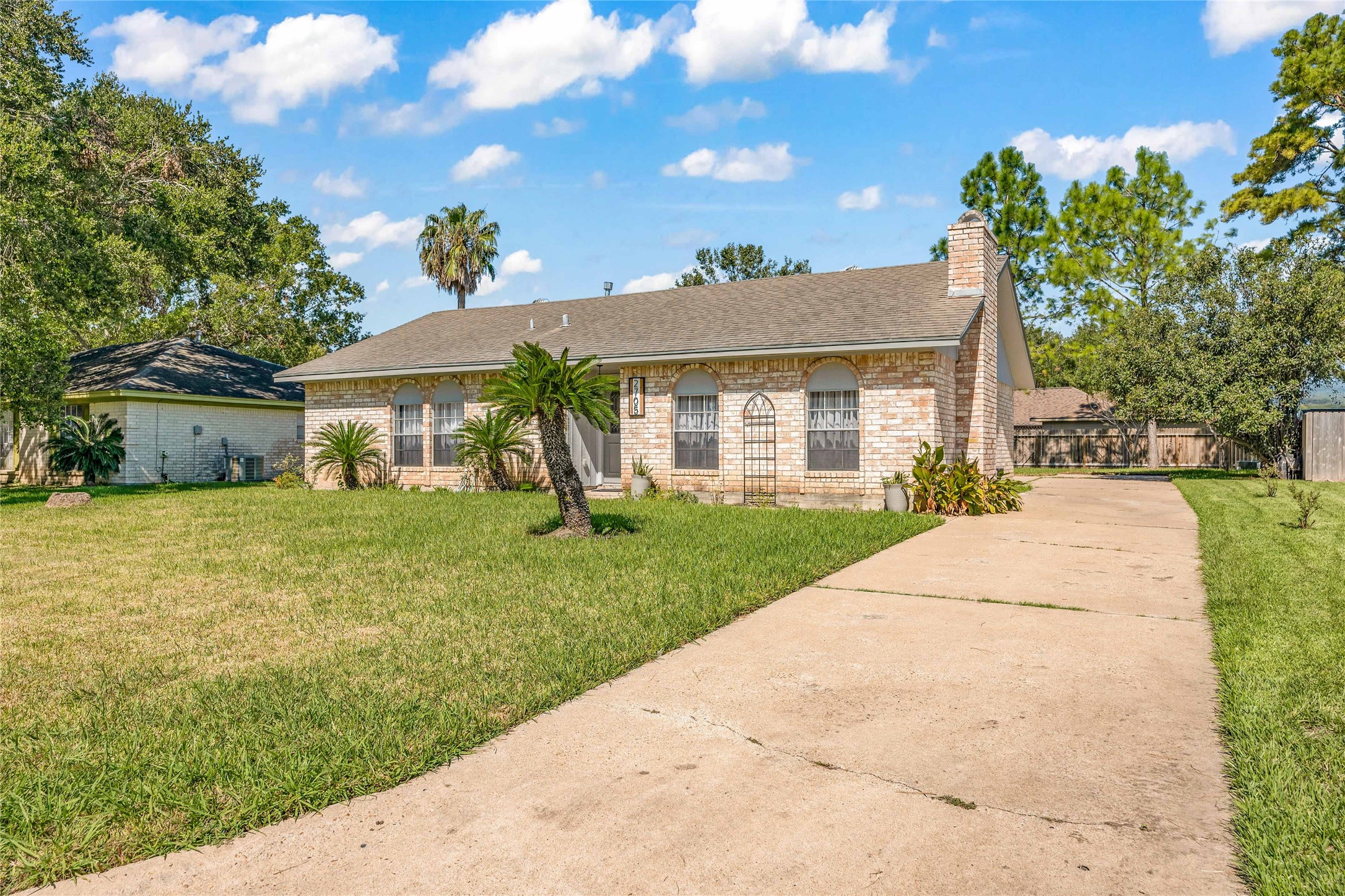 2705 Parrott Avenue Rosenberg, TX 77471 - Photo 3 of 27 a front view of a house with a yard and potted plants