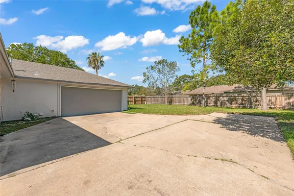 a view of a house with a yard and garage