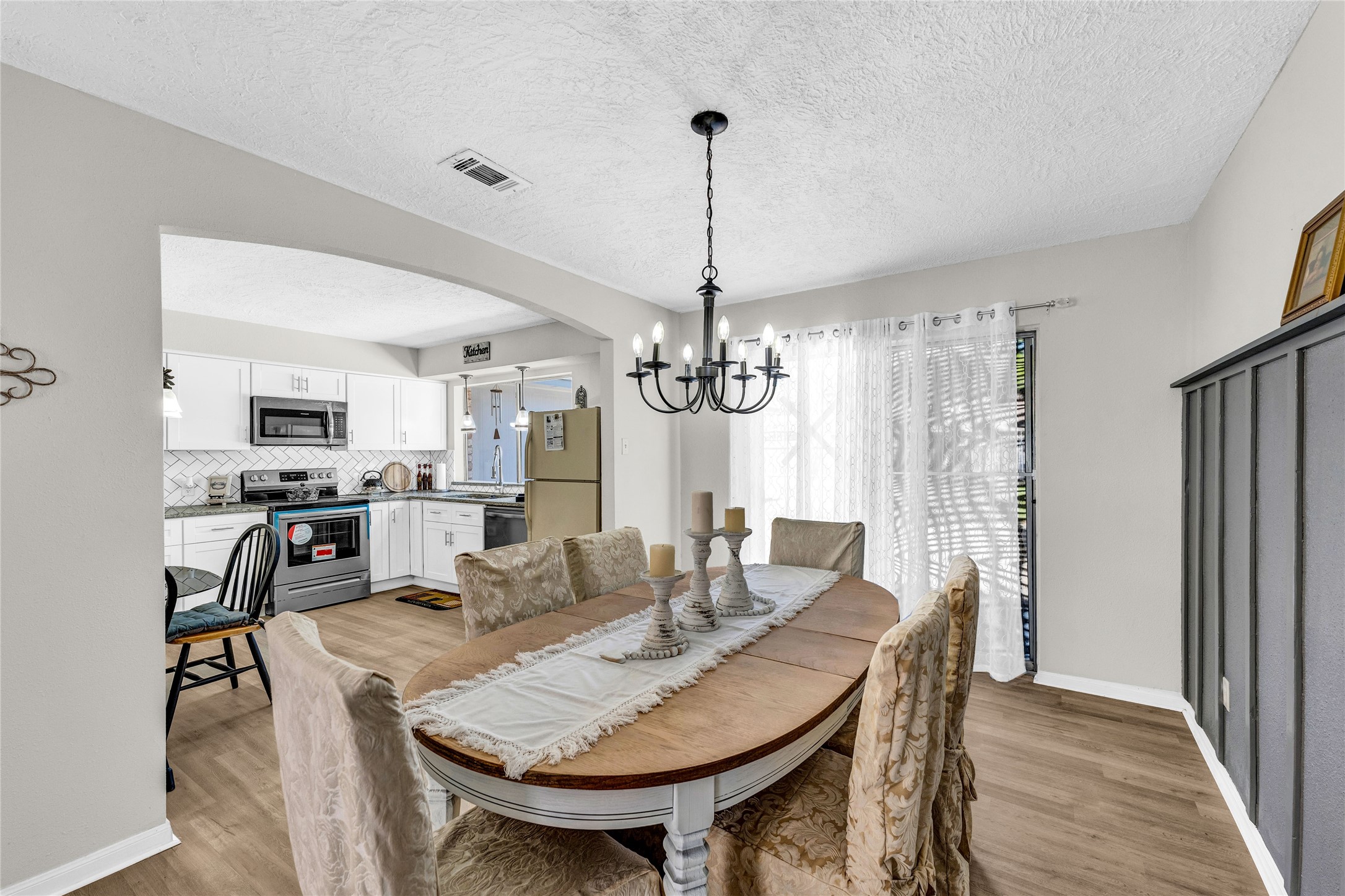 2705 Parrott Avenue Rosenberg, TX 77471 - Photo 9 of 27 a view of a dining room with furniture window and wooden floor