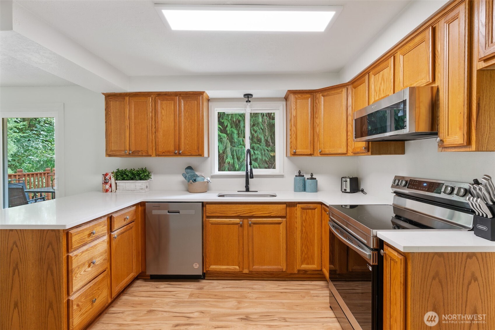 115 Maschke Road Vader, WA 98593 - Photo 12 of 40 a kitchen with a sink stove top oven and cabinets