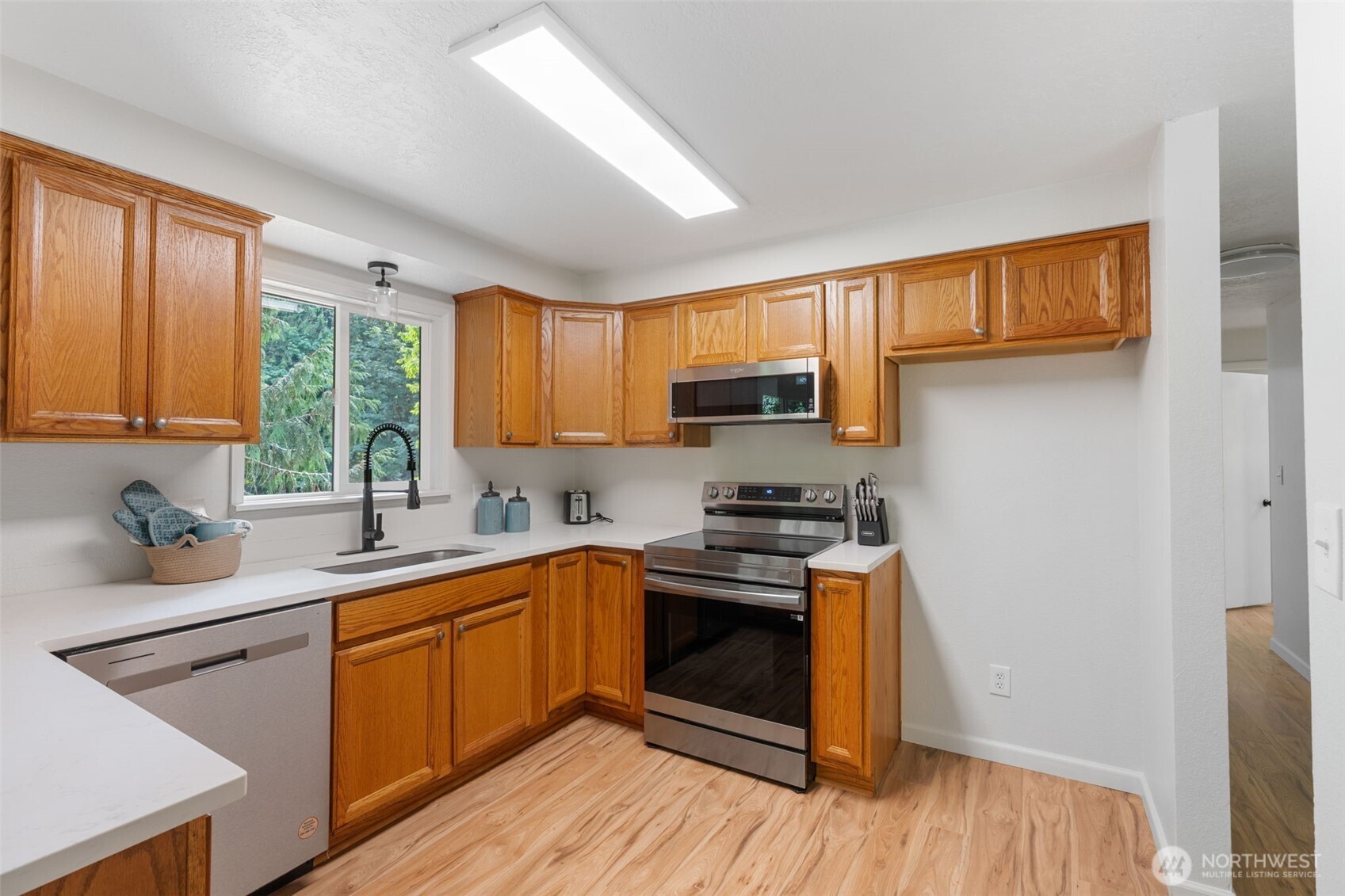 115 Maschke Road Vader, WA 98593 - Photo 13 of 40 a kitchen with stainless steel appliances granite countertop wooden cabinets a sink a stove a refrigerator with grey cabinets and wooden floor