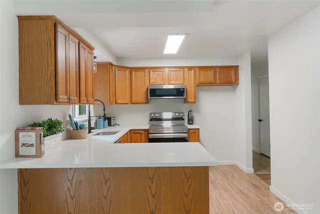 a kitchen with a sink a stove and cabinets