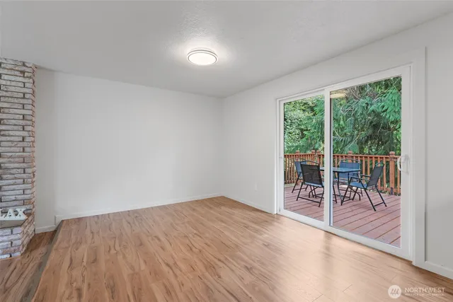 a view of a room with wooden floor and outdoor space