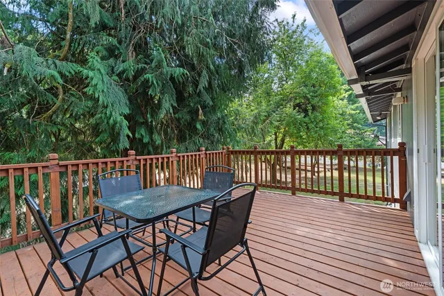 a view of a wooden chairs on the roof deck