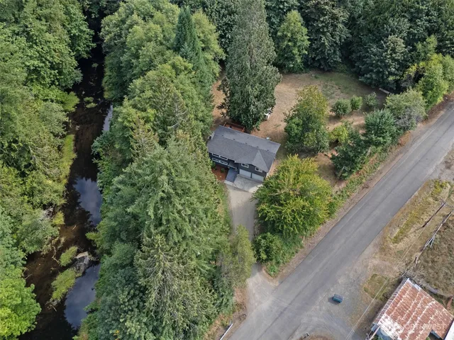 an aerial view of a house with a yard