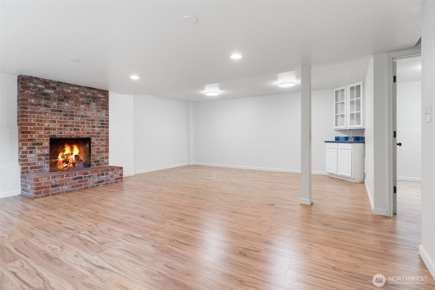 115 Maschke Road Vader, WA 98593 - Photo 9 of 40 a view of empty room with wooden floor and fireplace
