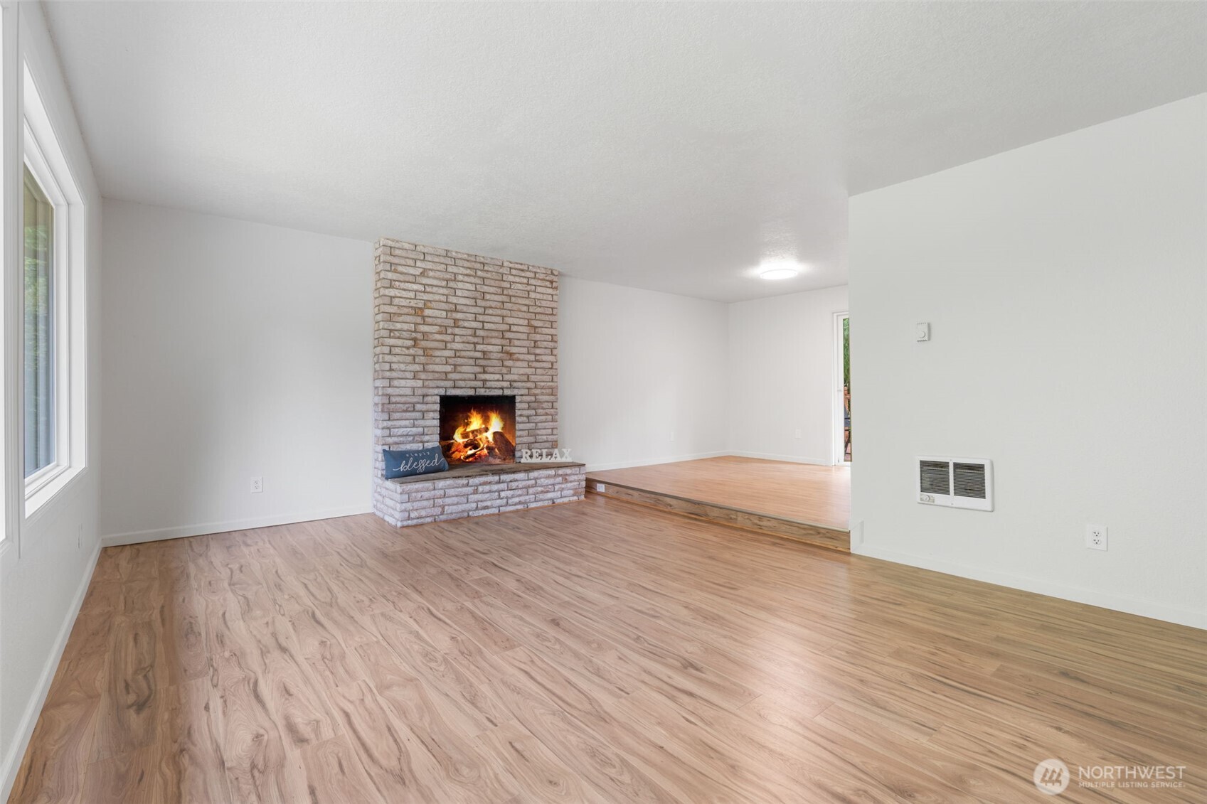 115 Maschke Road Vader, WA 98593 - Photo 10 of 40 a view of empty room with wooden floor and fireplace