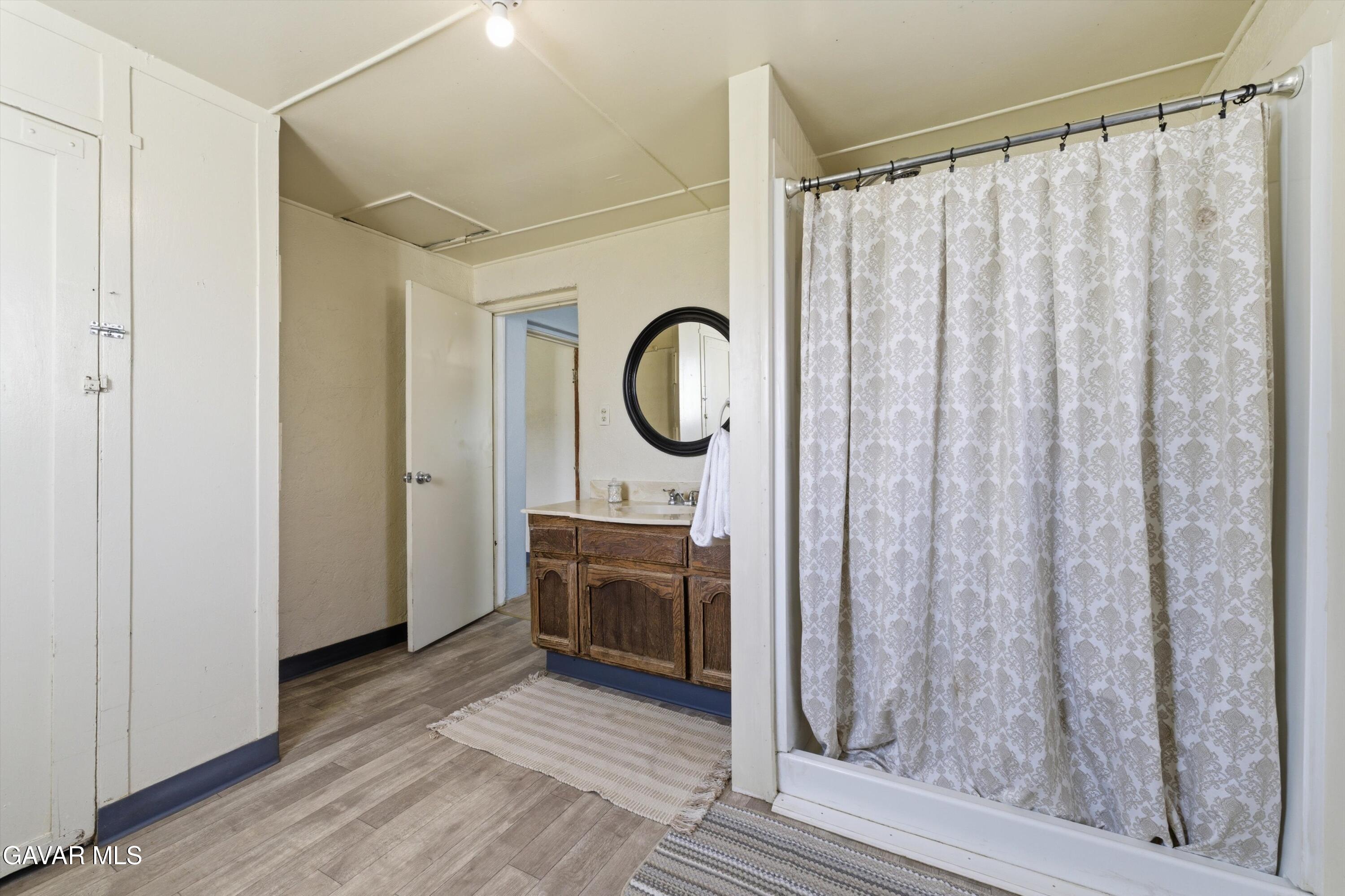 124 I Street East Tehachapi, CA 93561 - Photo 11 of 15 a bathroom with a sink a mirror and a shower