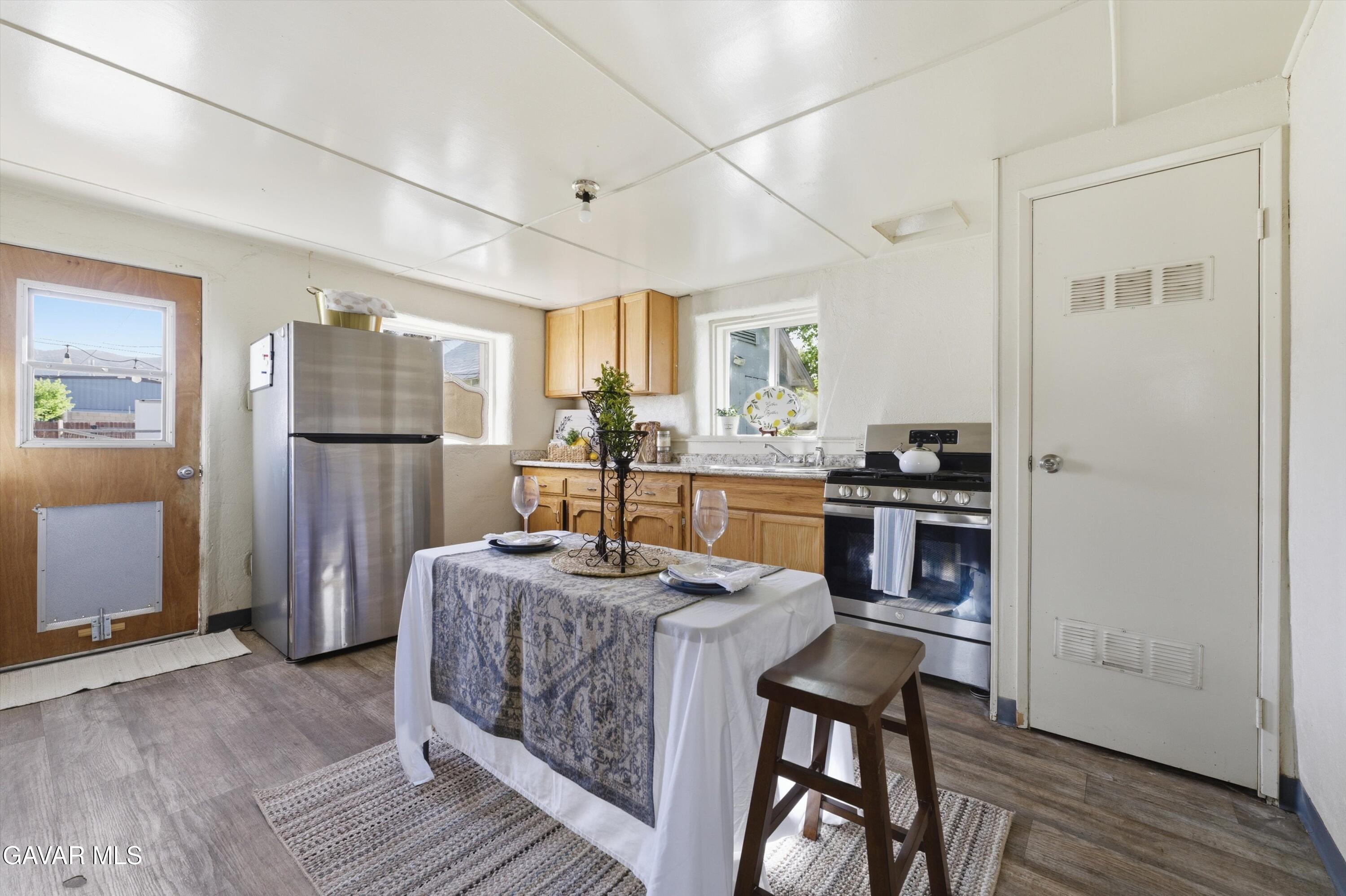 124 I Street East Tehachapi, CA 93561 - Photo 5 of 15 a kitchen with refrigerator cabinets and wooden floor