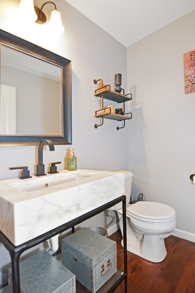 1711 Flagstone Drive Normal, IL 61761 - Photo 15 of 65 a bathroom with a sink a toilet and mirror