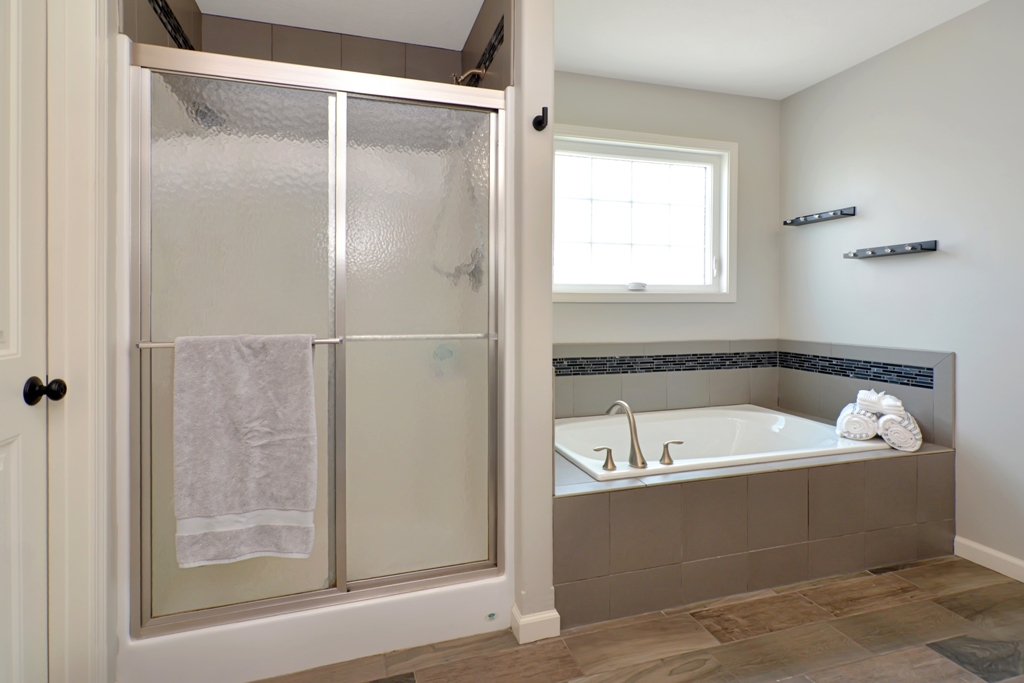 1711 Flagstone Drive Normal, IL 61761 - Photo 29 of 65 a bathroom with a tub a sink and a window