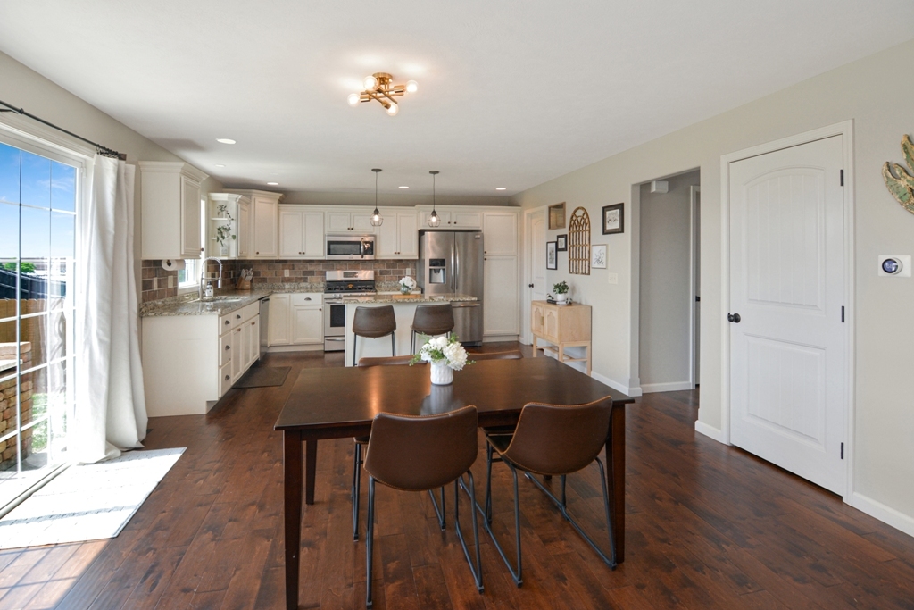 1711 Flagstone Drive Normal, IL 61761 - Photo 45 of 65 a view of a dining room and livingroom with furniture wooden floor a rug a painting and a chandelier