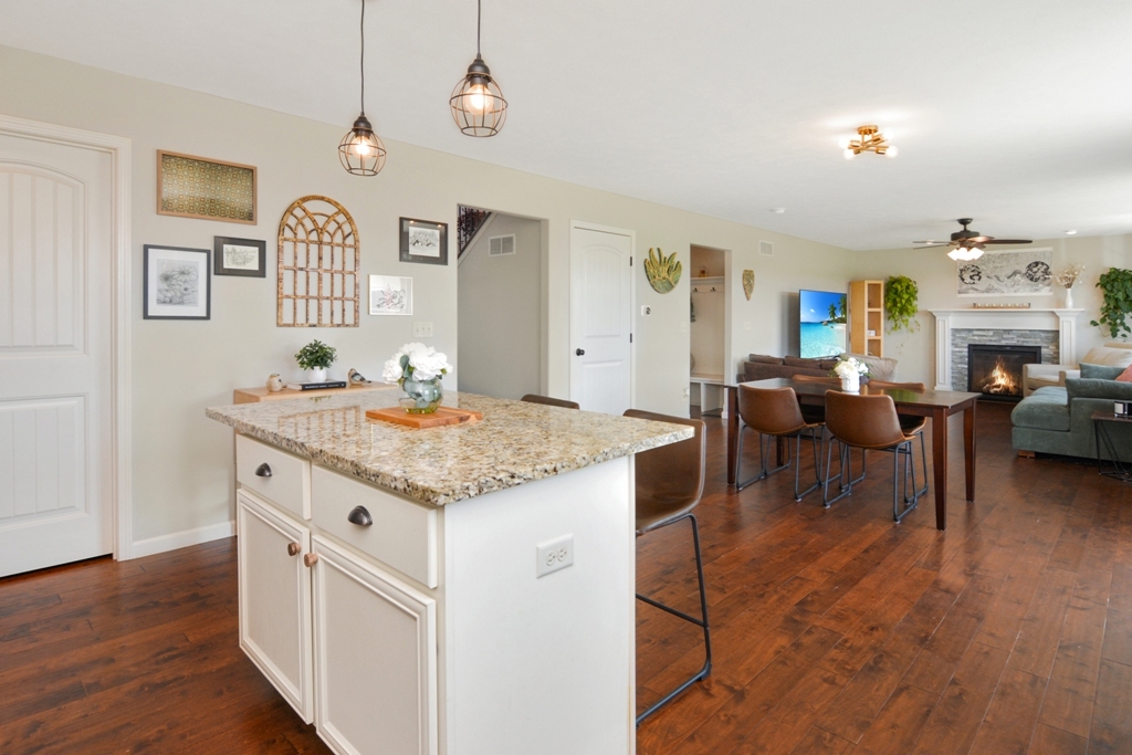 1711 Flagstone Drive Normal, IL 61761 - Photo 46 of 65 a open kitchen with stainless steel appliances granite countertop a stove and a living room with chair