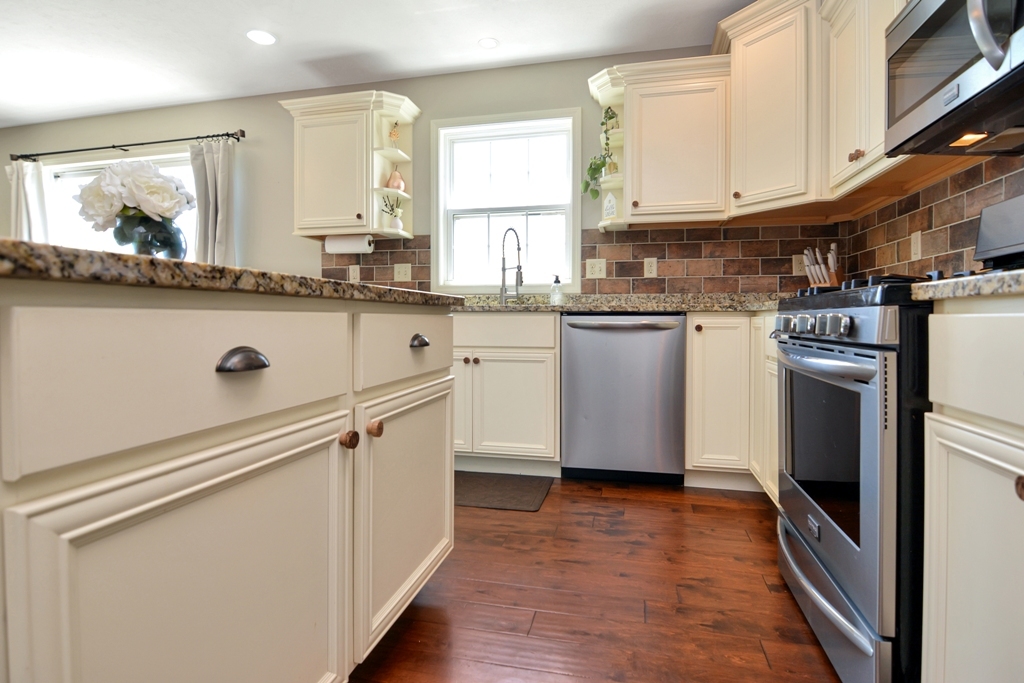 1711 Flagstone Drive Normal, IL 61761 - Photo 5 of 65 a kitchen with appliances a sink and cabinets