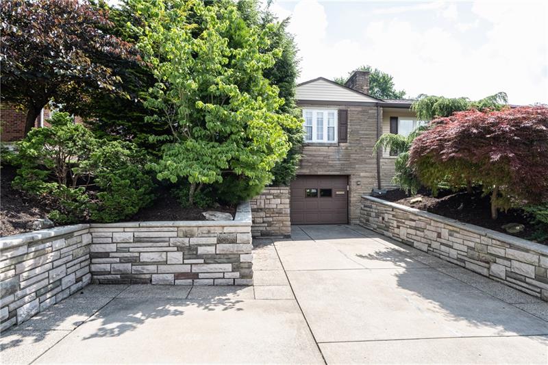 340 Orchard Spring Road Pittsburgh, PA 15220 - Photo 22 of 25 Extra wide driveway with stone retaining wall includes a bonus parking spot.