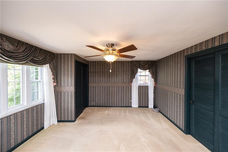 340 Orchard Spring Road Pittsburgh, PA 15220 - Photo 7 of 25 Master bedroom has his and her closets, neutral carpet and the window lets it tons of natural light.