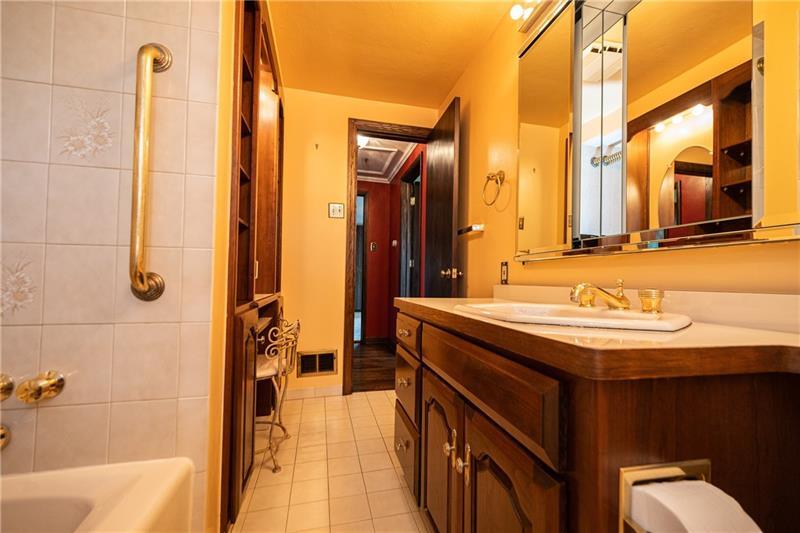 340 Orchard Spring Road Pittsburgh, PA 15220 - Photo 9 of 25 Updated full bathroom's bonus features include a built in make-up table, storage cabinet and laundry chute.