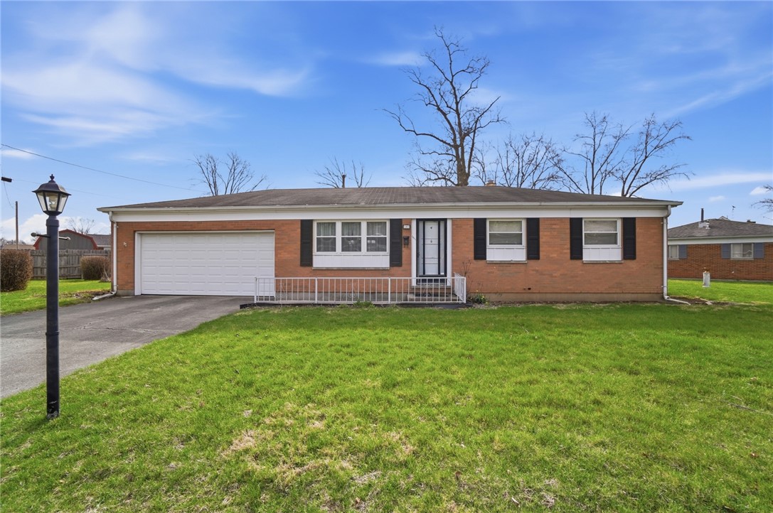 1087 Fairfield Road Troy, OH 45373 - Photo 2 of 39 This brick ranch offers a charming facade with a well-maintained lawn and convenient attached garage.