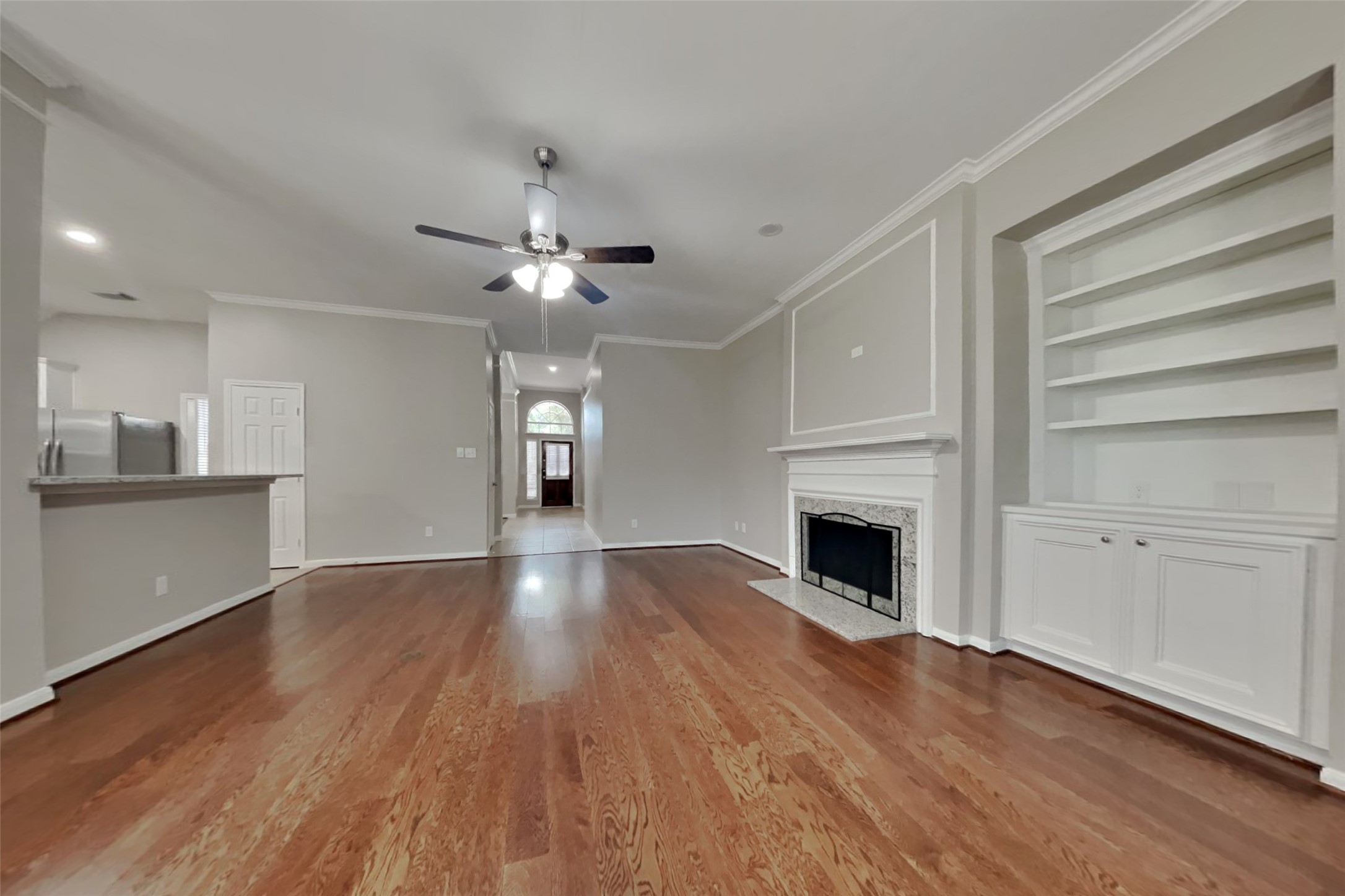 12711 Cedar Grove Court Humble, TX 77346 - Photo 2 of 20 a view of a livingroom with a fireplace a chandelier fan and windows