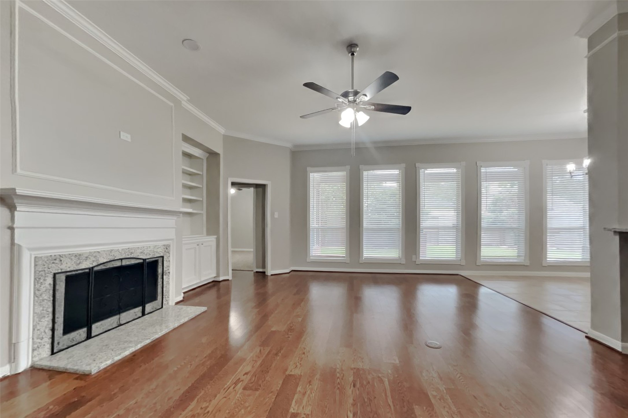 12711 Cedar Grove Court Humble, TX 77346 - Photo 3 of 20 a view of an empty room with wooden floor and a fireplace