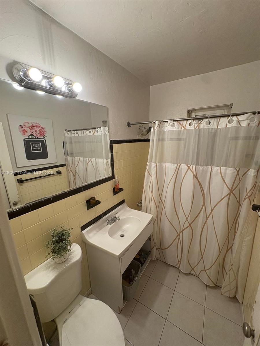 2255 Southwest 2nd Terrace Miami, FL 33135 - Photo 11 of 12 a bathroom with a sink mirror vanity and toilet