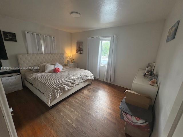 2255 Southwest 2nd Terrace Miami, FL 33135 - Photo 7 of 12 a bedroom with a bed and a chair