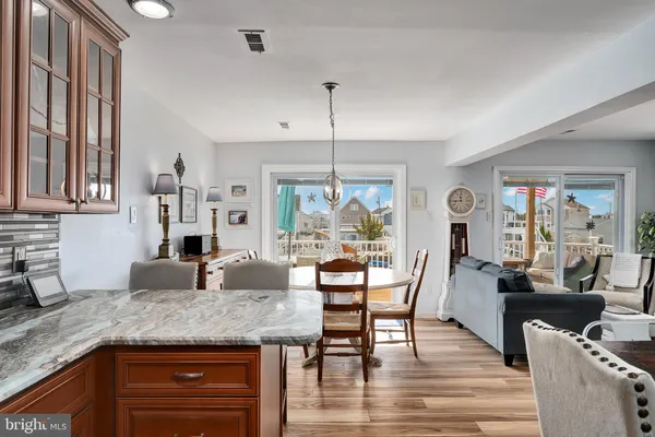 a kitchen with stainless steel appliances a refrigerator a stove top oven and a center island