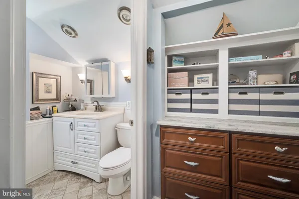 a spacious bedroom with a bed and a dresser
