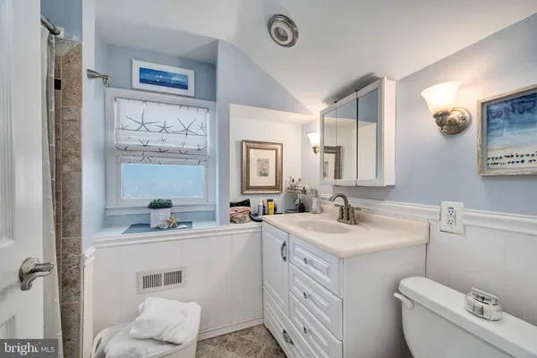 a bathroom with a toilet sink and shower