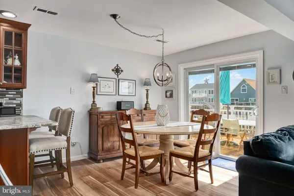 a kitchen with stainless steel appliances kitchen island granite countertop a refrigerator and a stove top oven