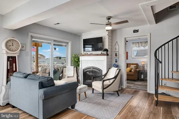 a living room with lots of furniture and a large window