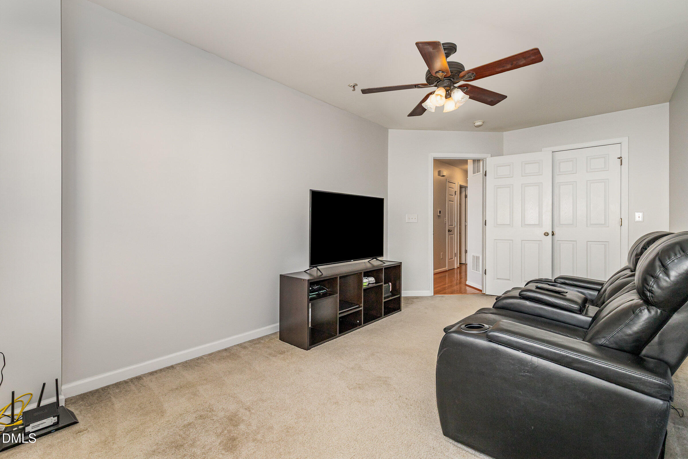 8620 Neuse Club Lane Raleigh, NC 27616 - Photo 21 of 26 a living room with furniture and a flat screen tv