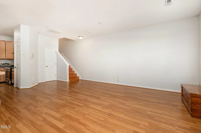 a view of an empty room with wooden floor