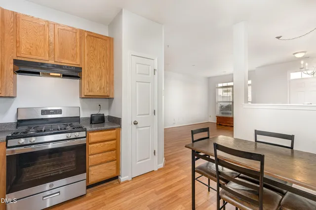a kitchen with granite countertop wooden floors and stainless steel appliances