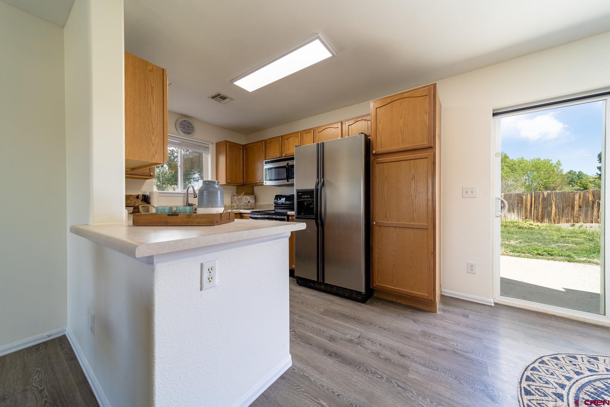 1531 Haystack Road Montrose, CO 81401 - Photo 12 of 34 a kitchen with a refrigerator sink and a cabinets