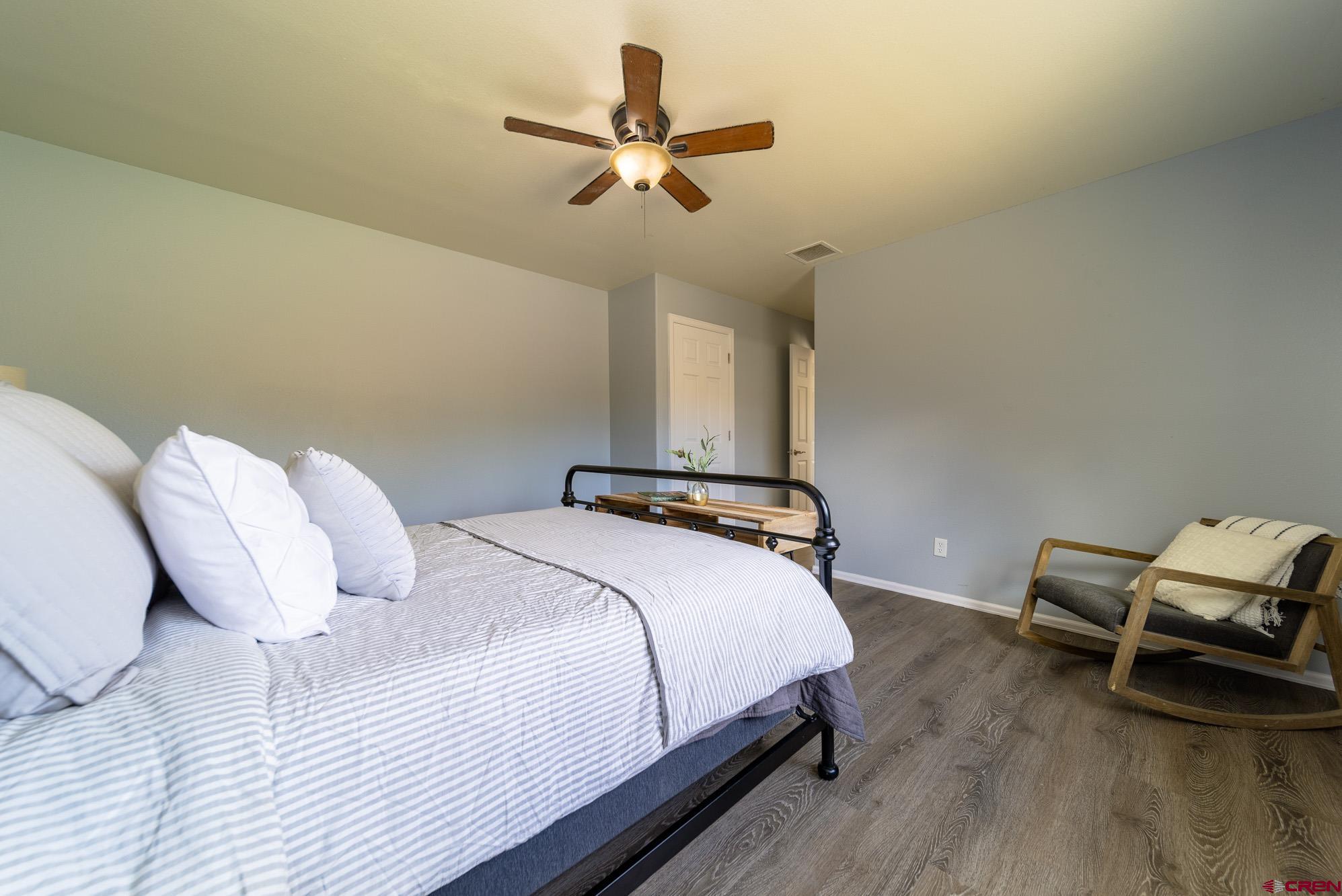 1531 Haystack Road Montrose, CO 81401 - Photo 15 of 34 a bedroom with a bed and a chandelier