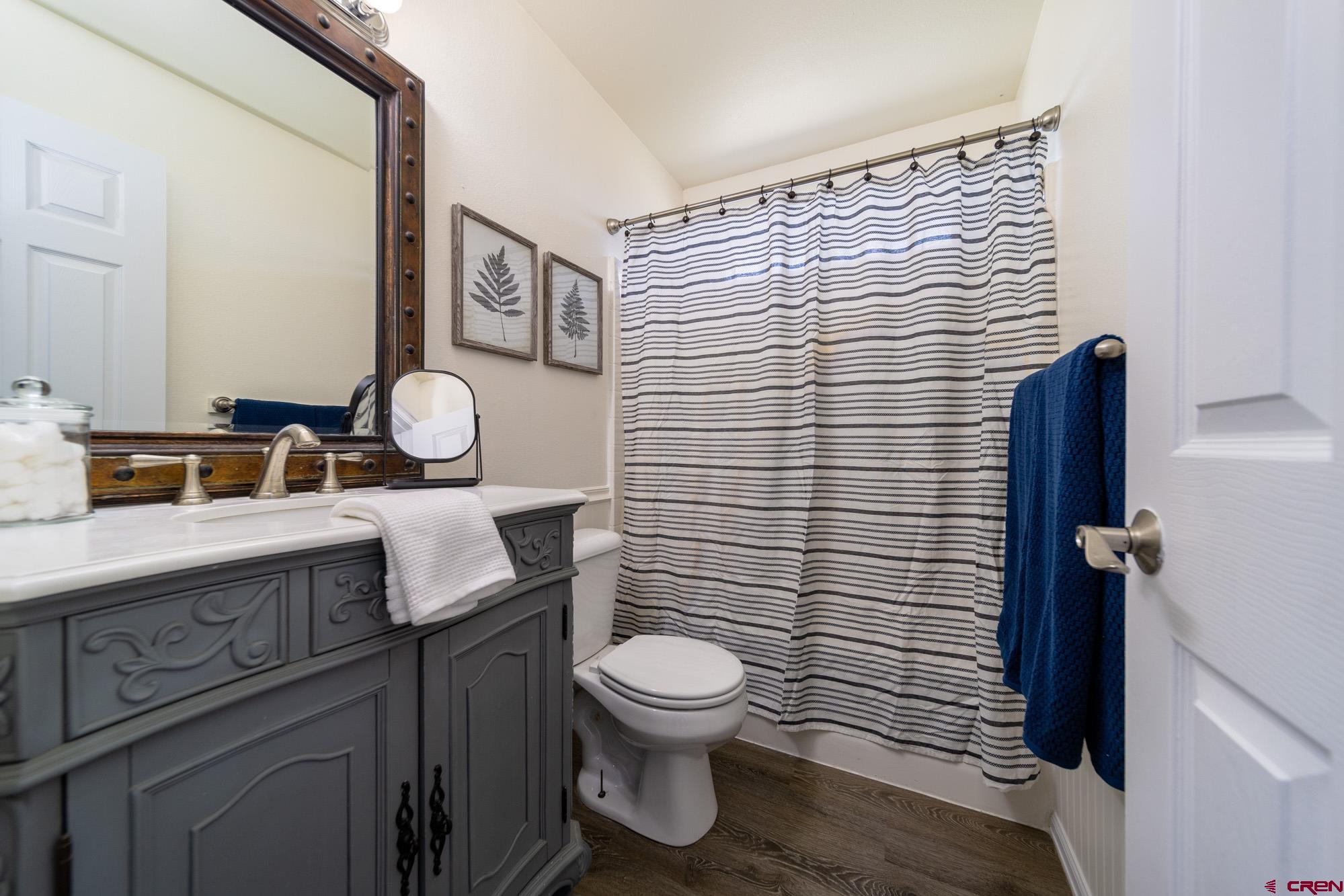1531 Haystack Road Montrose, CO 81401 - Photo 17 of 34 a bathroom with a granite countertop toilet sink and mirror