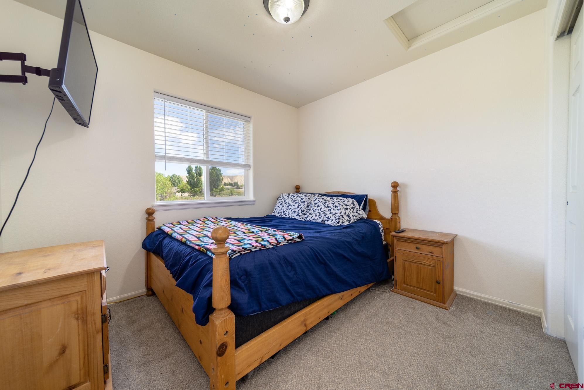 1531 Haystack Road Montrose, CO 81401 - Photo 18 of 34 a bedroom with a bed and window