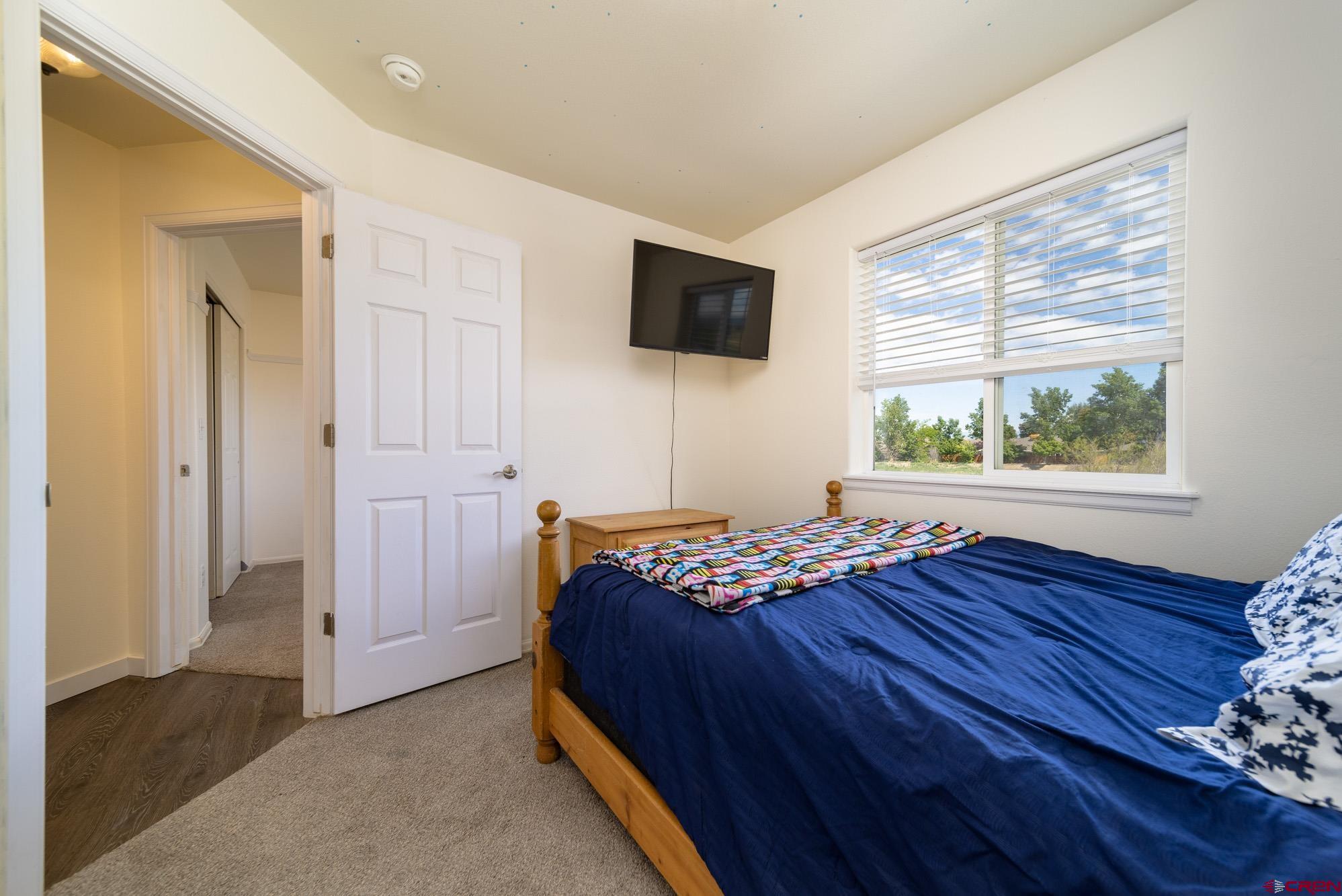 1531 Haystack Road Montrose, CO 81401 - Photo 19 of 34 a bedroom with a bed and a window