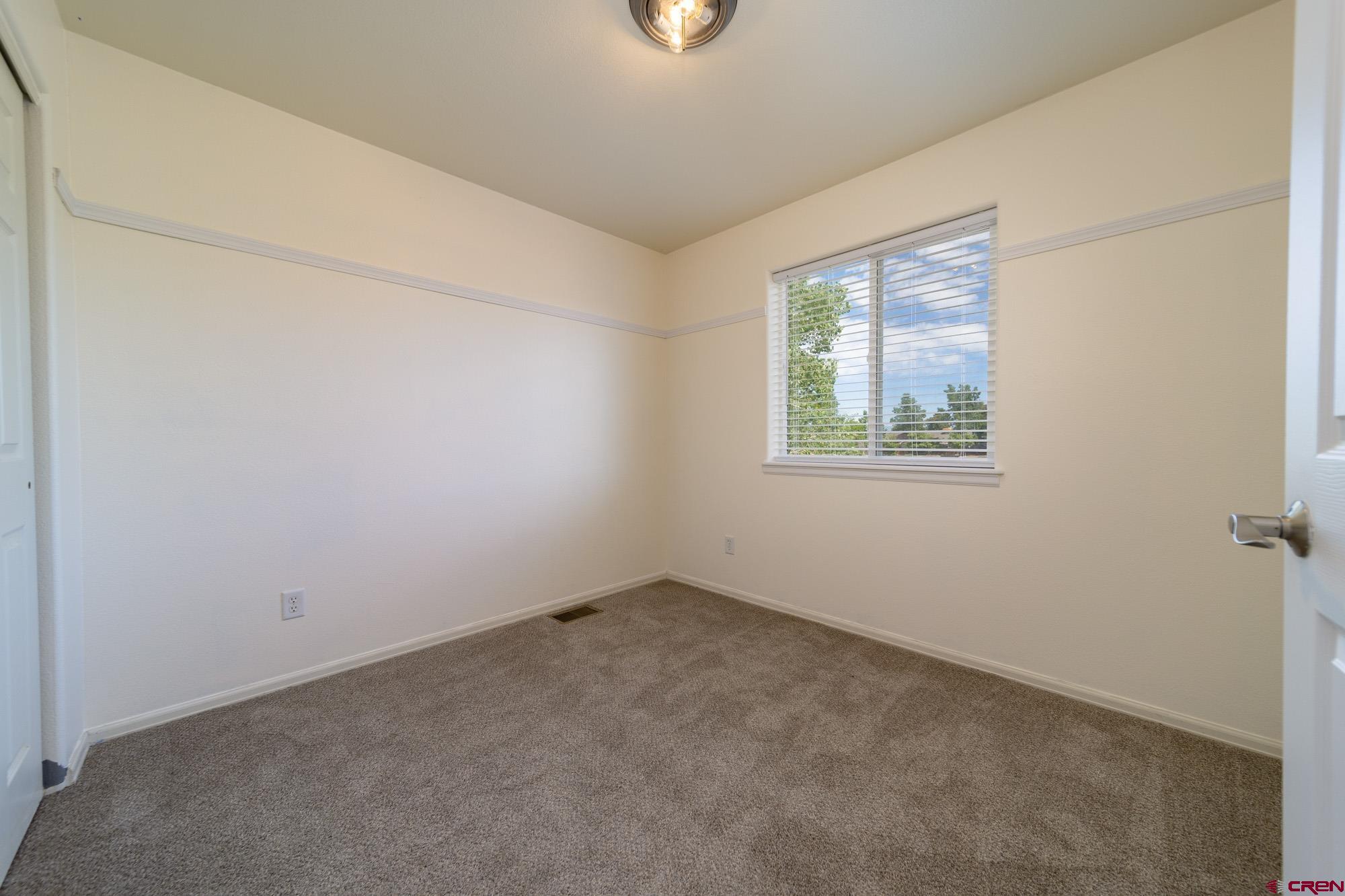 1531 Haystack Road Montrose, CO 81401 - Photo 21 of 34 an empty room with windows
