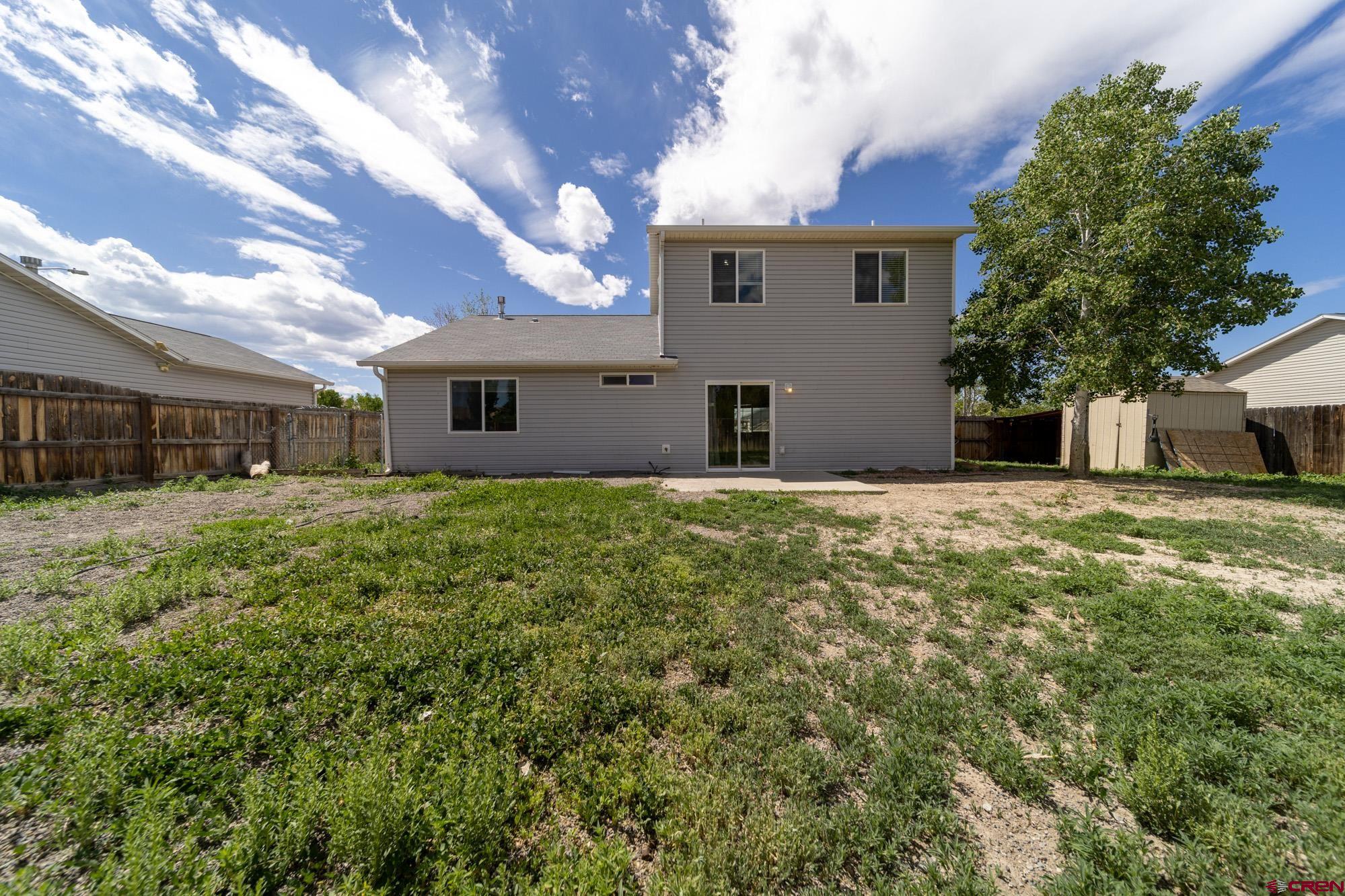 1531 Haystack Road Montrose, CO 81401 - Photo 28 of 34 a front view of house with yard and trees