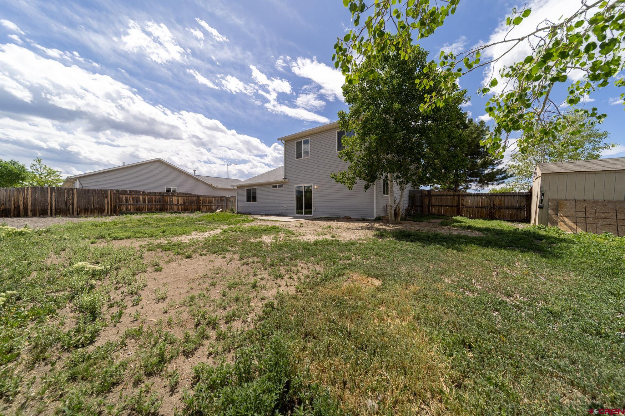 1531 Haystack Road Montrose, CO 81401 - Photo 32 of 34 a view of a house with yard and a tree